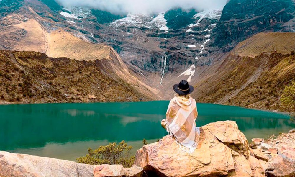 Traveler finding inner peace at Humantay Lagoon in the Andes