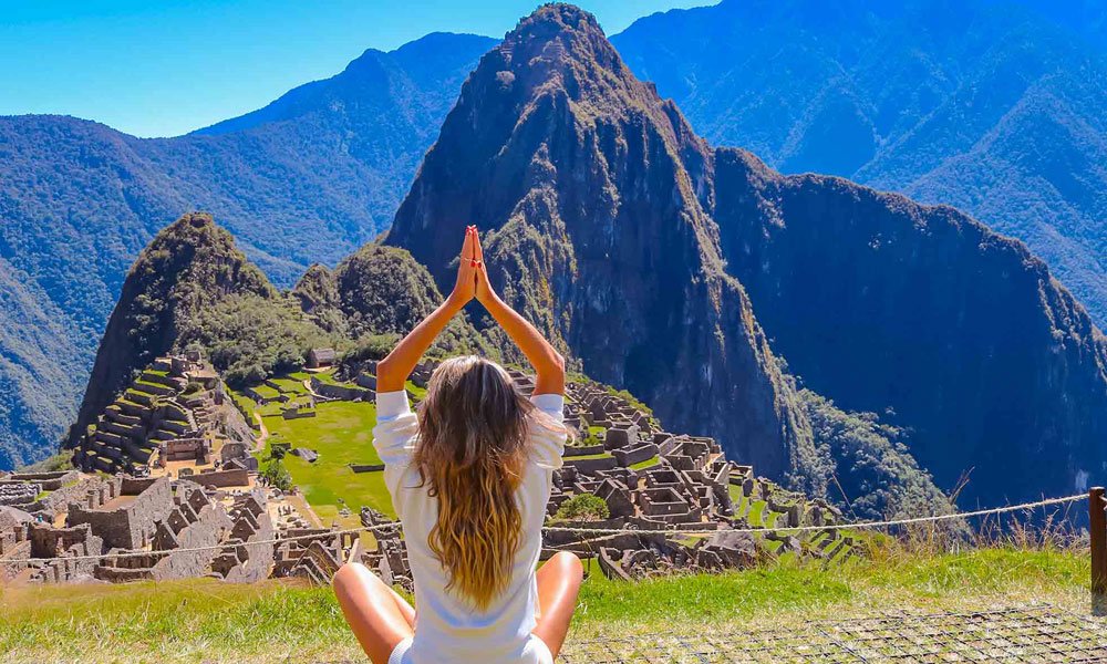 Traveler meditating at sunrise in the Andes — emotional healing journey